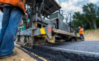 Paving new road with asphalt, road construction