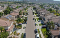 Suburban neighborhood street with big villas next to each other in southern California. Aerial view of residential modern subdivision house.